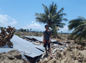 Joshua Micheal, 24, standing on the remains of his home in Petobo village, Palu