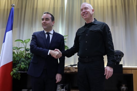 French Minister for the Armed Forces Sébastien Lecornu (L) shakes hands with Israel's Defence Minister Yoav Gallant during a meeting at the "Kirya", the Israeli army headquarters in the coastal city of Tel Aviv.