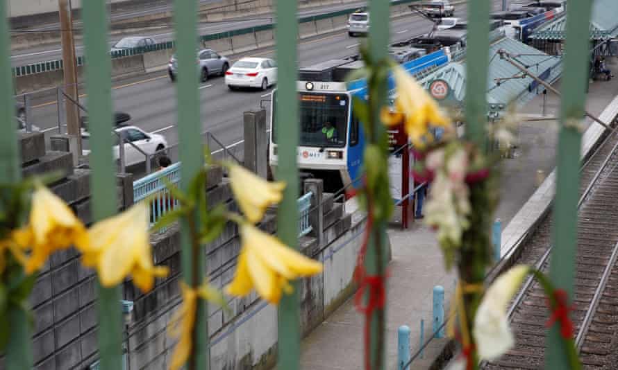 Flowers hang at a makeshift memorial for the two men who were killed on a commuter train in Portland.