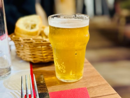 A pint of beer on a restaurant table
