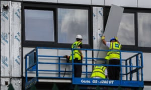 Cladding is removed from a tower block in Manchester for testing