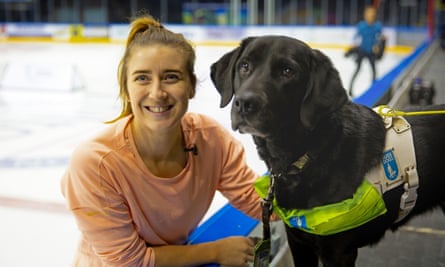 Libby Clegg and her guide dog, Hatti, rinkside.