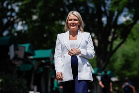 A blond woman standing outdoors