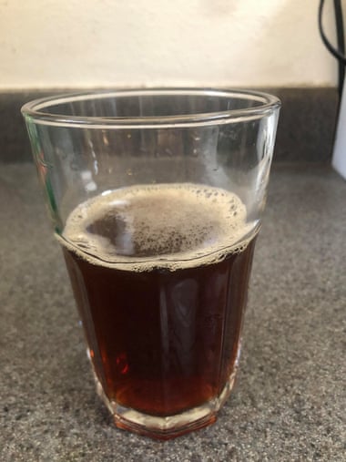 glass of carbonated liquid that looks like Coca-Cola