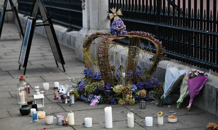 Candles are places around a wreath of flowers shaped as a crown.