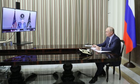 Vladimir Putin at a desk speaking to Joe Biden on a television screen.