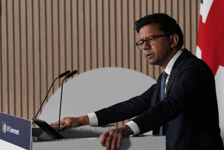 Kanishka Narayan gives a speech at a podium with a union jack flag behind him.