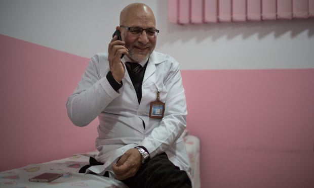 Dr Nader Alemi answers phone calls from patients and families
