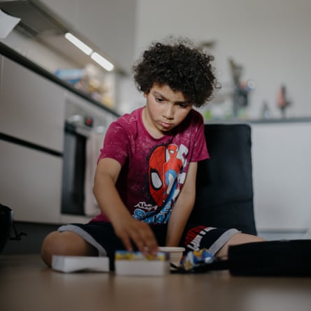Joanna’s eldest child, Jake, plays a magic trick in their flat in London. He loves performing and sharing what he learns with his siblings.