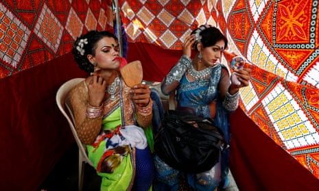 Eunuchs apply makeup before Raksha Bandhan festival celebrations in Mumbai