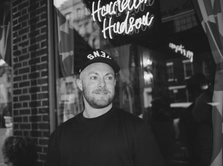 Man outside of plate glass window, smiling