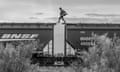 A migrant walks over a freight train known as the beast as he arrives at Piedras Negras, in Piedras Negras, October 2023