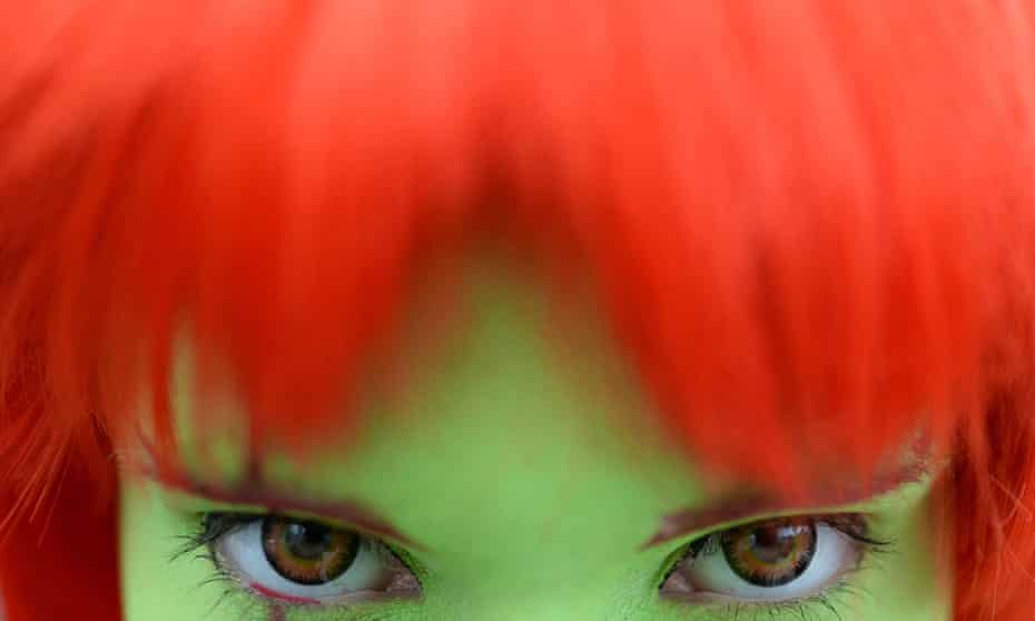 A woman wears coloured contact lenses.