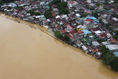 A swollen river inundating farm fields and houses in Ilagan town, Isabela province on 12 November, a day after Typhoon Toraji hit the province