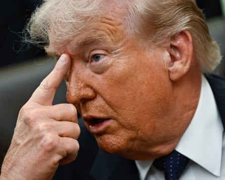 Donald Trump gestures by placing his index finger between his eyebrows as he speaks before signing a proclamation in the Oval Office on Tuesday