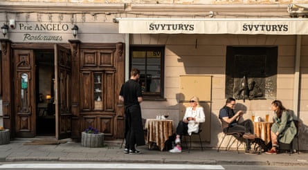 Customers sitting in the sun outside a bar/restaurant in Vilnius