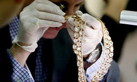 Christie’s auction house appraiser David Warren examines a piece of jewellery.
