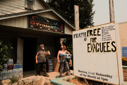 a man and a woman standing by a sign
