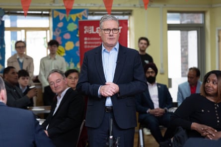 Starmer in a meeting hall with supporters