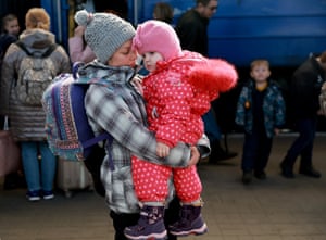 Ola carries her baby Alisa as she arrives at the main train station on Thursday in Lviv, Ukraine.
