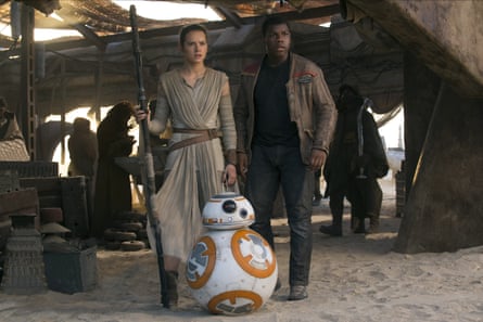 Daisy Ridley as Rey and John Boyega as Finn, with droid chum BB-8, in 2015’s Star Wars: The Force Awakens