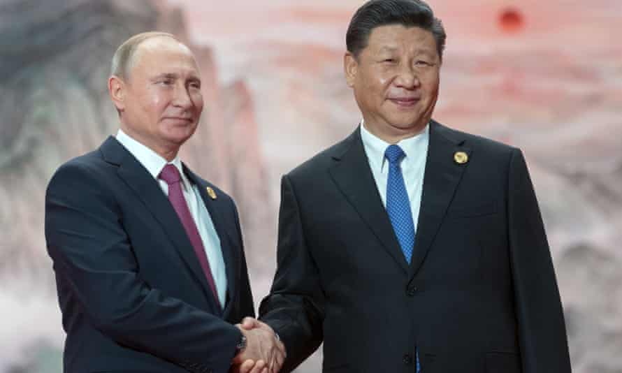 Russia’s president, Vladimir Putin, left, shakes hands with China’s president, Xi Jinping