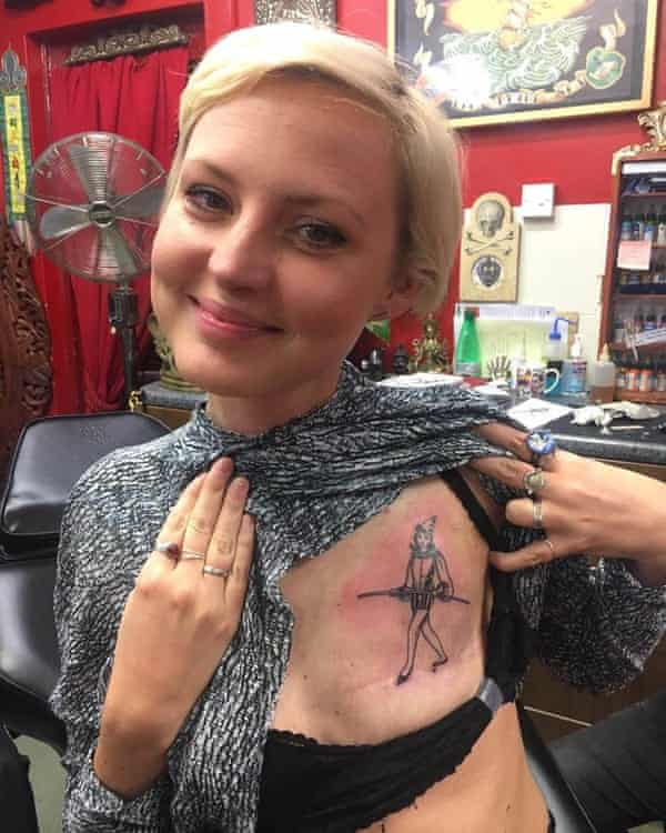 Hallenga showing the tattoo she has on her mastectomy scar.