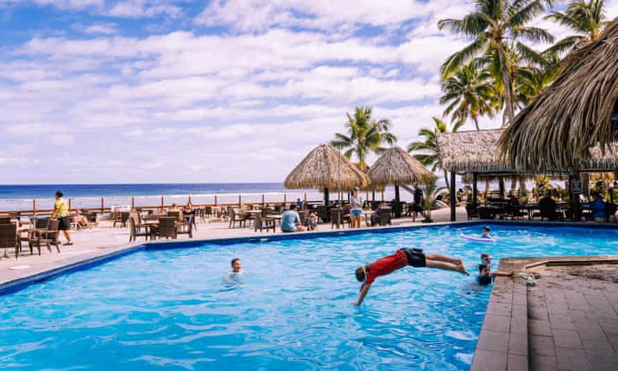Tourists play in the pool at a resort in Rarotonga, Cook Islands.