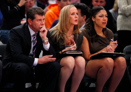 Shea Ralph sits adjacent to UConn coach Geno Auriemma connected nan chair during a game.