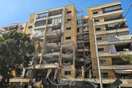 An apartment building with many of its walls and windows ripped out by a missile blast
