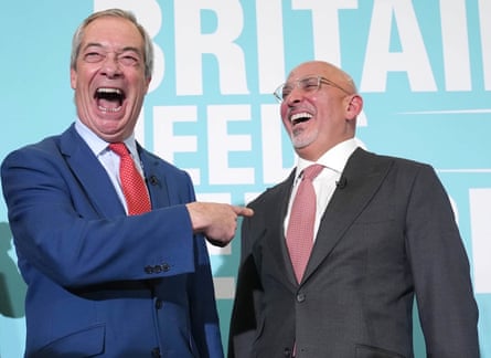 A smiling Farage points his finger at a laughing Zahawi