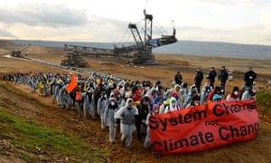 Protesters holding a banner reading ‘System change not climate change’ after an action to blockade coal operations at Hambach opencast mining prior to the UN Climate Change Conference COP23, close to Kerpen, Germany, 5 November 2017.