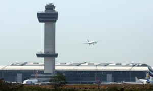 An aircraft flies past the control tower as it prepares to land at New York’s John F Kennedy airport.