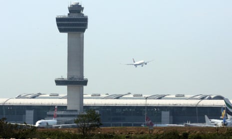 An aircraft flies past the control tower as it prepares to land at New York’s John F Kennedy Airport.
