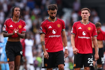 A dejected Bruno Fernandes trudges disconnected pinch his teammates.