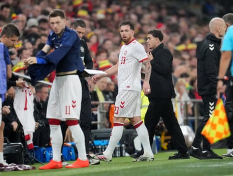 Denmark's Pierre Hojbjerg leaves the pitch with an injury.
