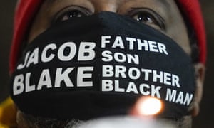 Jacob Blake Sr, father of Jacob Blake, holds a candle at a rally for his son last night in Kenosha.