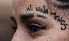 A woman protester in Argentina with the slogan 'ni una menos', 'not one less' on her face