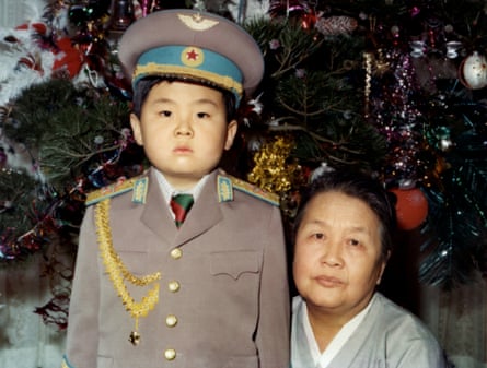 Kim Jong-nam dressed in an army uniform poses with his maternal grandmother in January 1975.