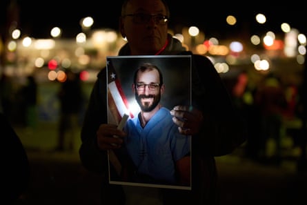 A person holds a picture during a vigil for Alex Pretti on 28 January.