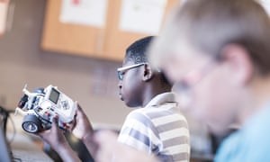 Schoolboy playing with exploring a mechanical toy