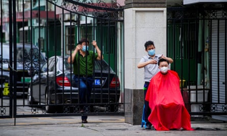 A resident gets a haircut on a street in Shanghai.