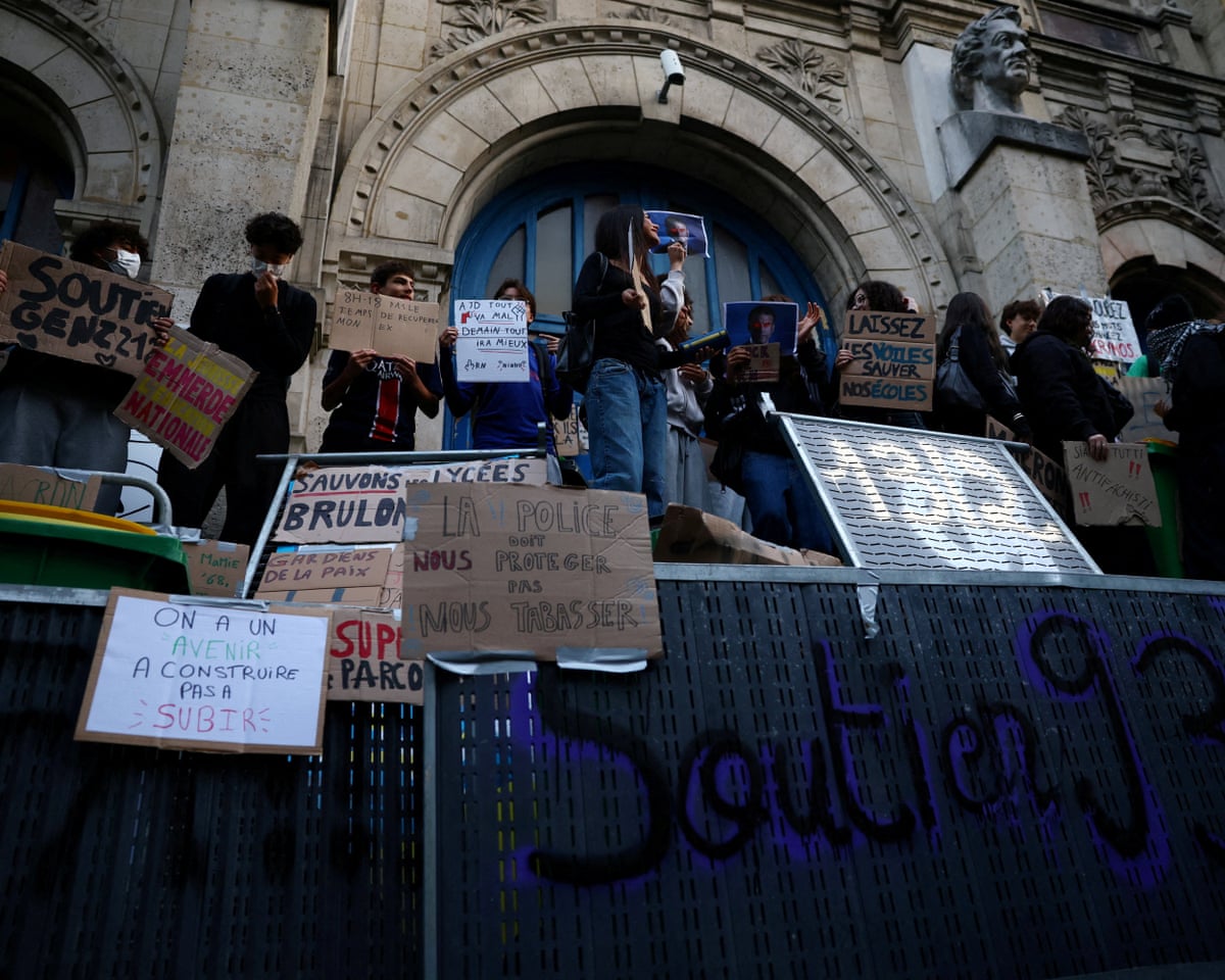 French high school students gather outside the Lycee Voltaire high school in France.