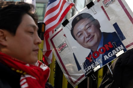 Great Again' below a photo of the former president next to a young man in a red scarf with US flag behind