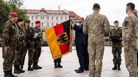 Friedrich Merz with flag and troops
