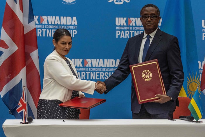 Priti Patel and Vincent Biruta, the Rwandan foreign affairs minister, shaking hands after signing an agreement at Kigali Convention Center today.
