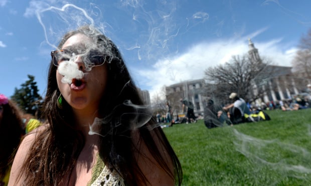 A woman blows rings with marijuana smoke during an event in in Denver, Colorado.