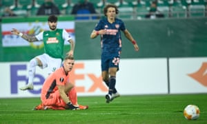 Arsenal goalkeeper Bernd Leno (centre) watches the ball go in.