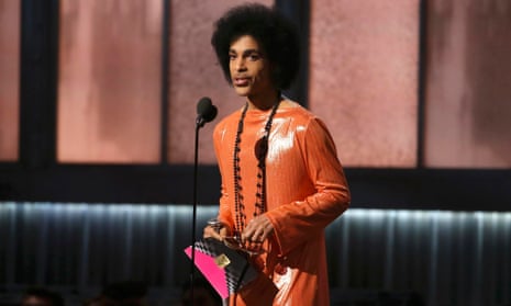 Prince presents the award for album of the year at the 57th annual Grammy Awards in Los Angeles.