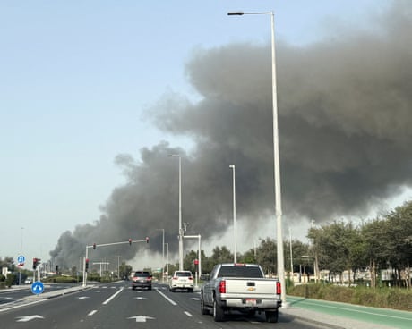 Smoke billows from Zayed port, Abu Dhabi, United Arab Emirates seen from along a highway